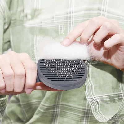 Smart pet grooming tool with self-clean button